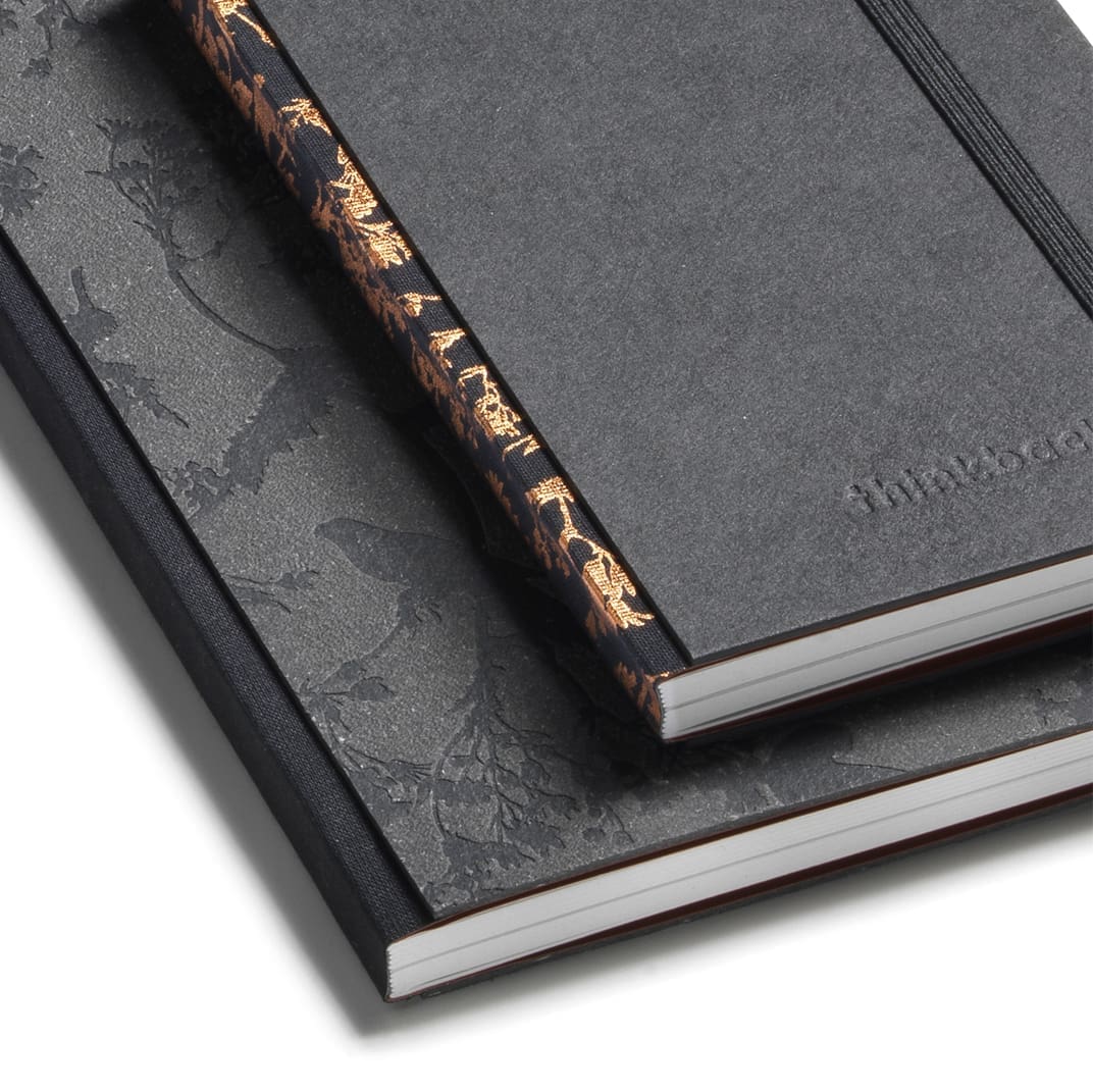 Custom stationery featuring notebook spines in recycled paper
