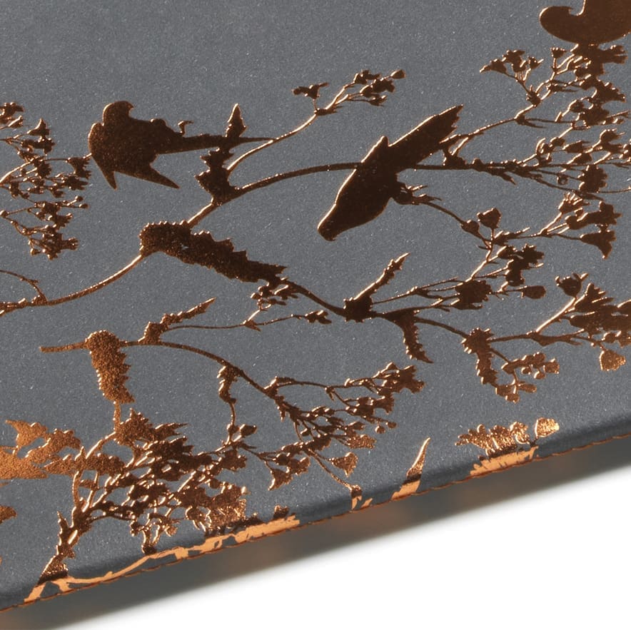 Detail of bronze hot foil stamping on black recycled paper