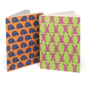 Pups ruled notebook in A5 with soft straw paper cover and recycled pages, 2 assorted colors.