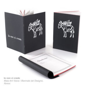 Io non ci credo plain notebook by Mala Arti Visive with red edge and cardstock cover.